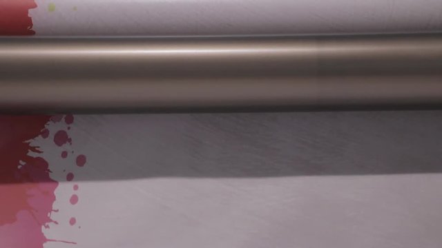 Industrial Big Printer, professional press, and paper supply. Robotized workflow, detailed shot while processing large, vinyl, glossy, rolls. Color samples before final ok. Engineering.