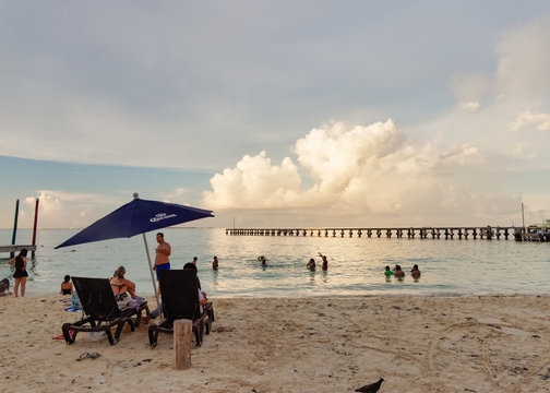 Tropical beach with bathers under the umbrella, Playa Caracol, Boulevard Kukulcan, Zona Hotelera, Canc&uacute;n, Mexico, in September 8, 2018