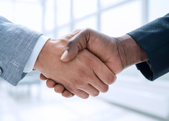 Business handshake in lofty office