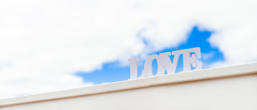 Word love with blue sky background