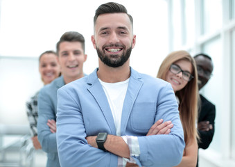 Confident business team standing and smiling with folded arms