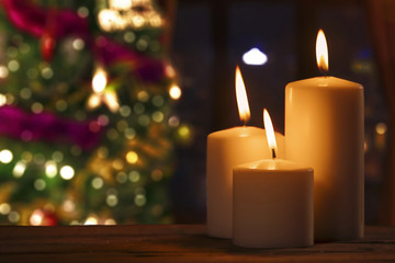 Burned candles with blurred Christmas tree