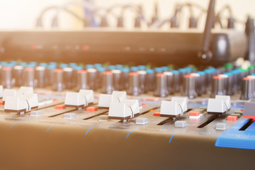 Close up Volume adjusting knobs old on audio mixer controller in control room