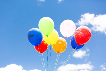 Multicolored balloons against the sky
