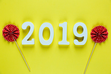 white wooden Numbers 2019 on the yellow background. creative Christmas and New year background