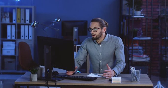 Male Caucasian freelancer working over the project on his computer anf beeing surprised and happy from a result.