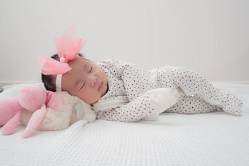 4 weeks old newborn baby laying down sleeping