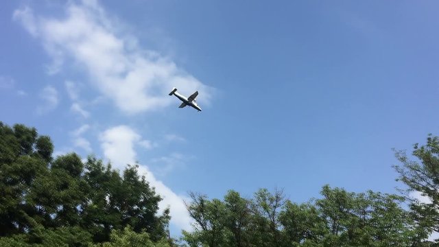 Light aircraft crossing the blue sky