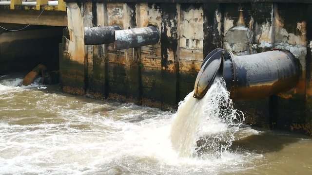 Environmental Video After a heavy rain the sewer system of the big city is draining through wastewater treatment into the canal through the drain door to prevent flooding and Environmental protection.