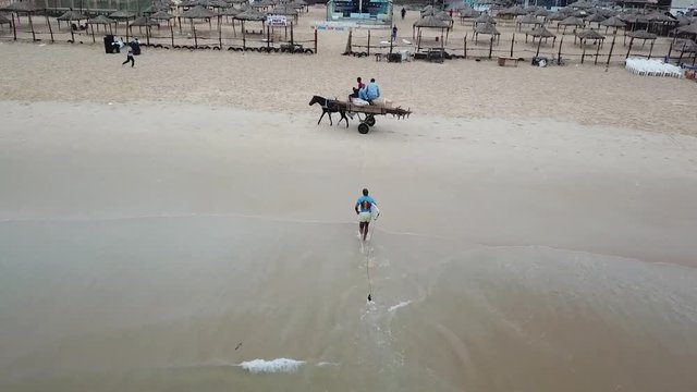 surfer running on beach africa