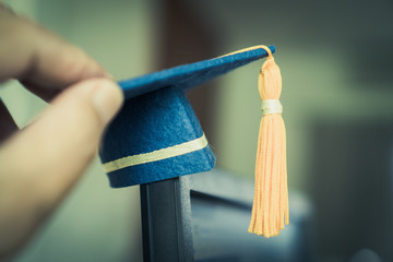 Graduation cap on hands show success in education learning study international abroad