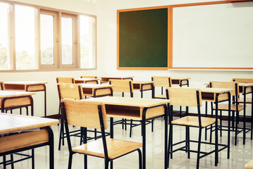 Empty School classroom with desks chair wood, greenboard and whiteboard in high school Thailand, vintage tone education concept