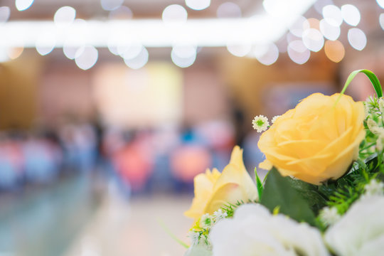 Abstract blurred of conference hall or seminar room photo with flowers foreground and background