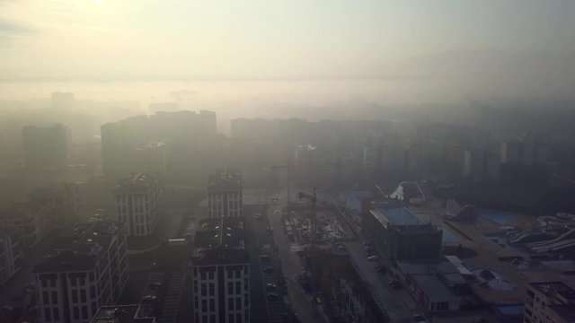 Flying over a concrete living apartment area in east Europa with many birds flying around the drone
