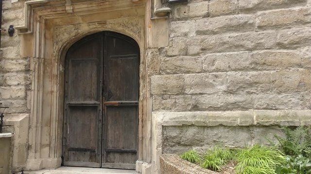 The Wooden door of an old stone building.