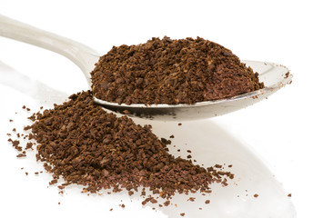 spoon of coffee grounds with white background