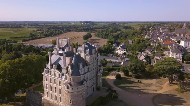 Chateau de Brissac in the Loire Valley of France. A medieval Castle Located in the Countryside, Surrounded by Vineyards and Farmland Shot with 4k Aerial Drone