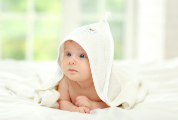 Baby with blue eyes in a towel.
