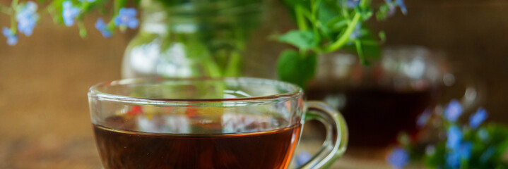 Two cups of tea and summer flowers
