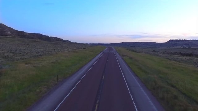 A drone pan down a country highway somewhere in the middle of Wyoming.