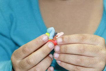 child with dirty hand of modeling clay