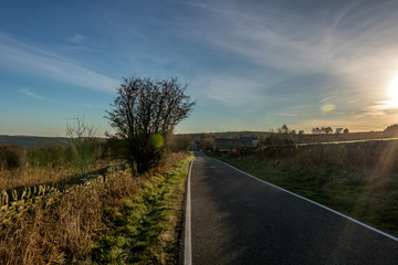 Side road captured during early morning sunset with nice sky, clouds and colors around road