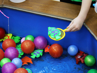 Fototapeta na wymiar fishing in the paddling pool. Children's toys in the pool.