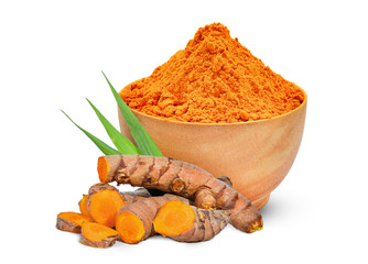 turmeric root and turmeric powder in the wood bowl with green leaves isolated on white background