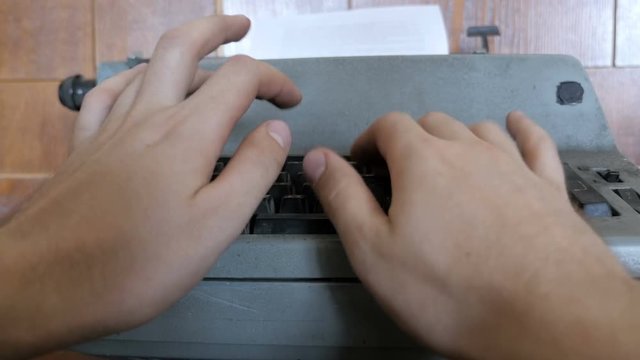 Close up of male hands typing on the old typewriter
