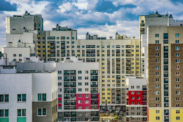 The facade of the new residential high-rise buildings against the sky . The concept of building a typical residential neighborhood