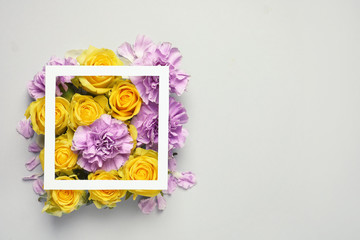 Flat lay composition with beautiful blooming flowers on grey background