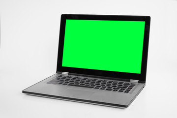 Fototapeta premium Laptop or notebook with chroma green display on a isolated background