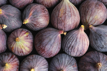 Many whole fresh purple figs as background, top view