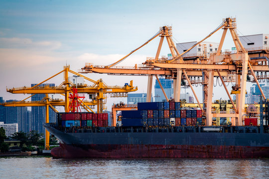 Container Cargo ship and cargo plane with working crane bridge in shipyard during sunrise,logistic import export and use for freight cargo.