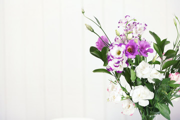 Bouquet of beautiful flowers on blurred background. Space for text