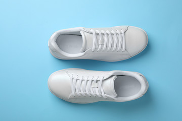 Pair of sneakers on color background, flat lay