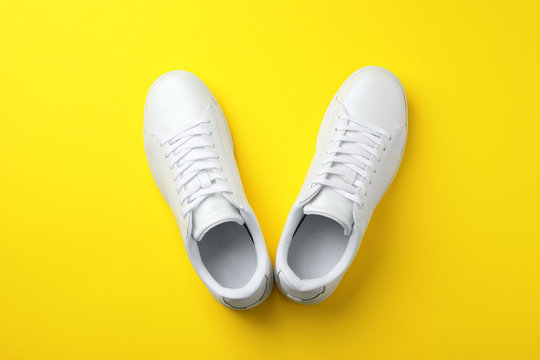 Pair of sneakers on color background, flat lay