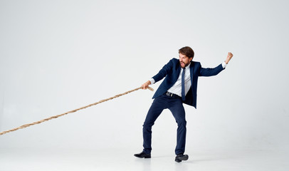 business man strong pulls the rope