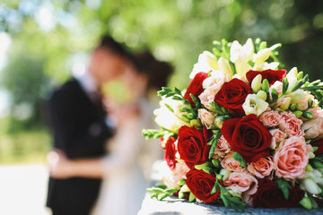 wedding bouquet in front of the newlyweds