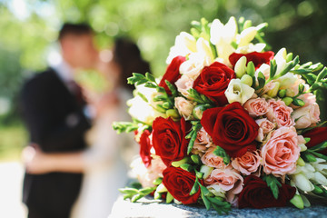 wedding bouquet in front of the newlyweds