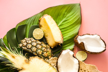 tropical fruits with leaves on a pink background