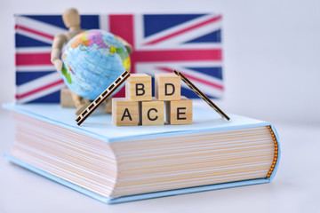 English aplhablets and the lean ladders on the book with world globe and England flag symbol...