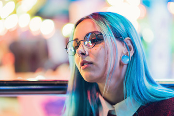 Hipster girl with blue dyed hair and sequins as freckles. Woman in red clothing and nose piercing,...