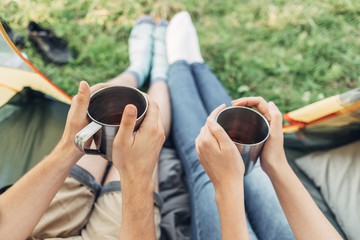 Happy Young Couple Sitting in the Tent and Having Picnic on the Nature