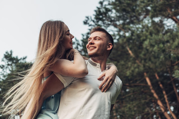 Beautiful Young Couple Have Fun at Sunset Outside of City
