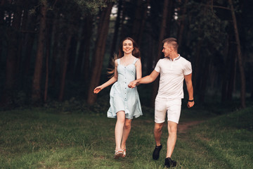 Fototapeta premium Beautiful Young Couple Have Fun at Sunset Outside of City