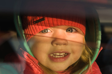 little girl looks out of the car