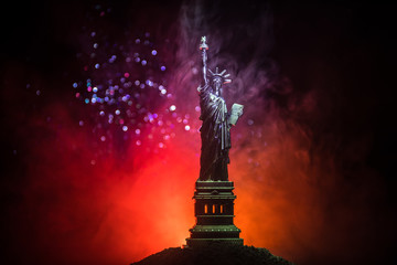 Silhouette statue of liberty on dark toned foggy background. Statue of Liberty on the background of colorful dawn sky © zef art