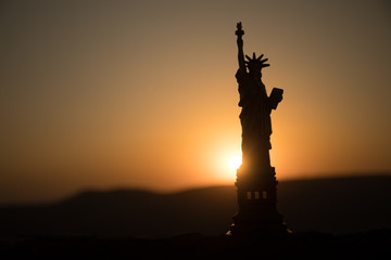 Statue of Liberty on the background of colorful dawn sky