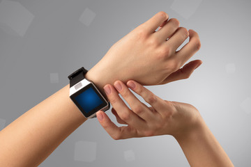 Female hand wearing smartwatch with free space on the screen